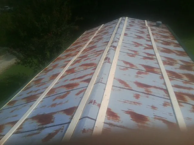 Rusted metal roof panels with new wood purlins before replacement — Storm Damage Roof Repair in Pinetown by Roofing Brothers